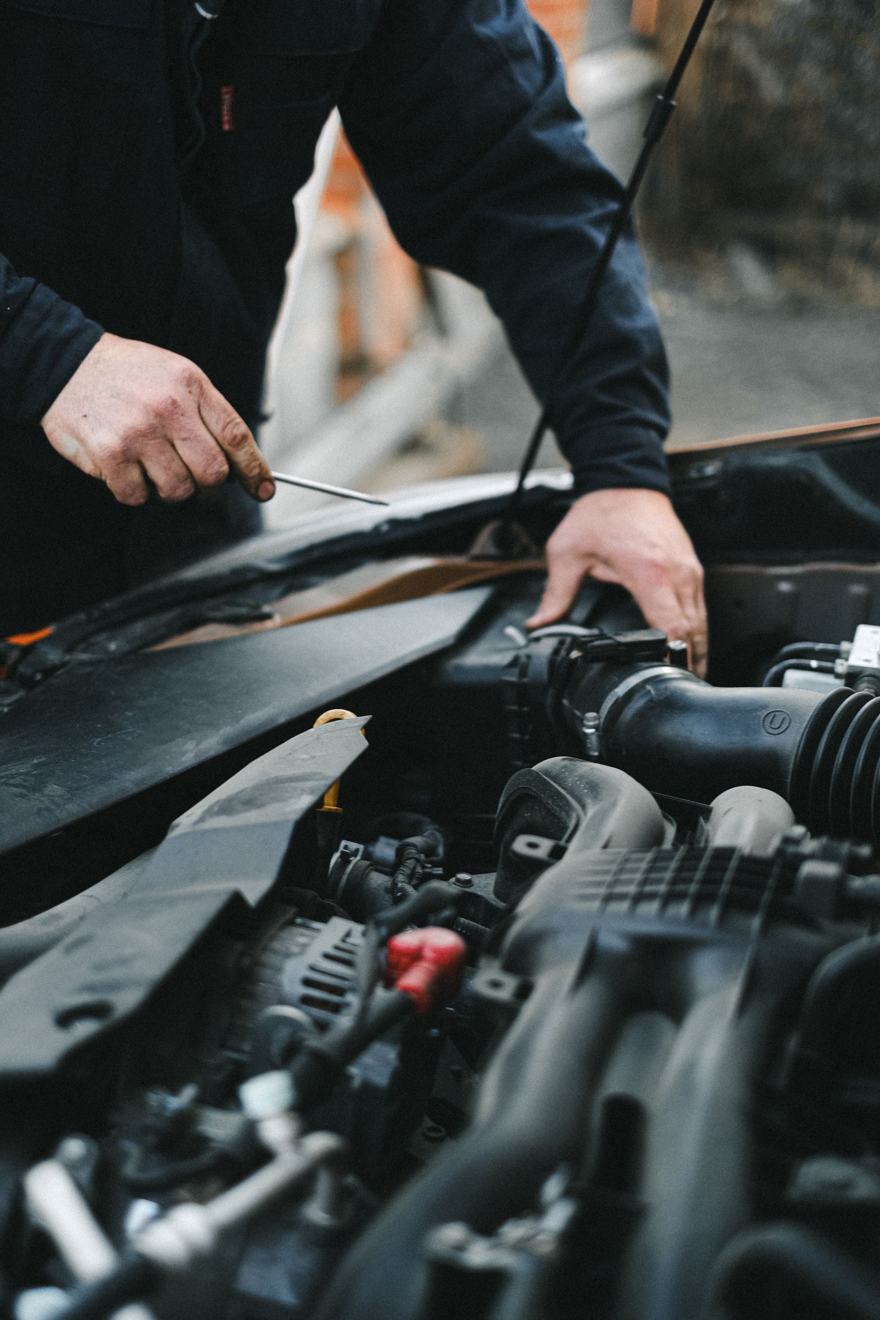 Illustrative stock photograph of hands working on a passenger vehicle engine